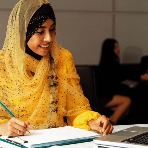 A student checks a certified Arabic transcript translation using Arabic Translation Services in Pennsylvania for admission.