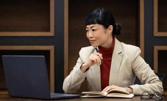 A client reviews a certified Vietnamese contract on a laptop, using Vietnamese Translation Services in Pennsylvania.